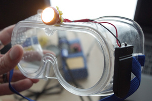 Goggles with mounted batteries and lamp